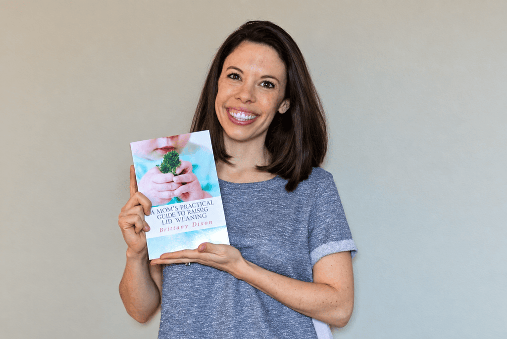 baby led weaning book Brittany holding her book, A Mom's Practical Guide to Baby-Led Weaning