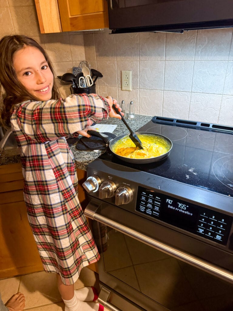 child cooking breakfast